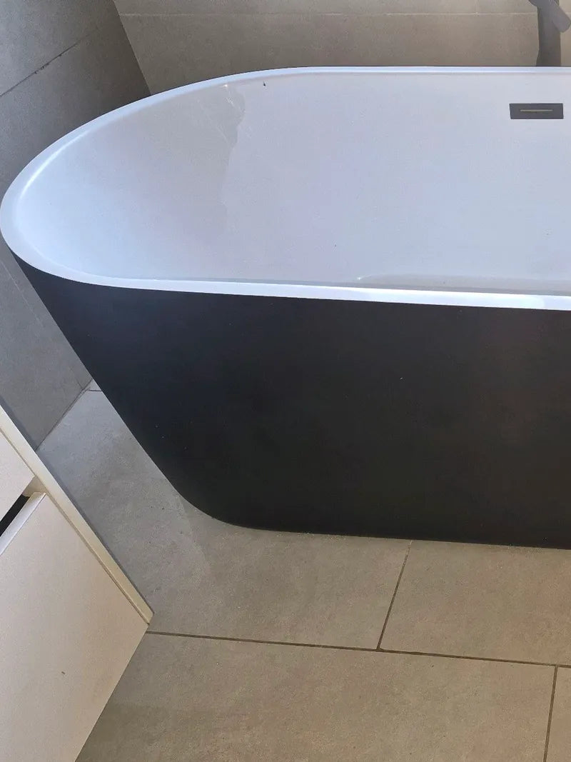 A new freestanding bath on a tiled bathroom floor